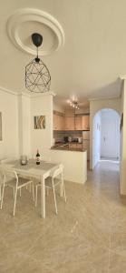 a living room with a table and a kitchen at Sunny Hill Apartment in Ciudad Quesada
