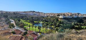 a town on a hill with trees and a river at Sunny Hill Apartment in Ciudad Quesada