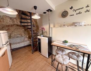 a kitchen with a table and stools in a room at IL COLLE Holiday Home - FIUGGI - Charming independent home in the historic center, near the Thermal Baths & Wellness Retreats in Fiuggi +29 photos