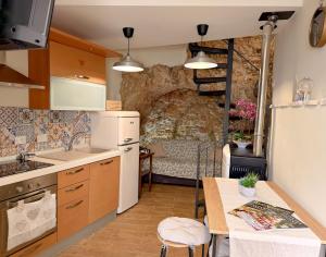 a small kitchen with a table and a dining room at IL COLLE Holiday Home - FIUGGI - Charming independent home in the historic center, near the Thermal Baths & Wellness Retreats in Fiuggi