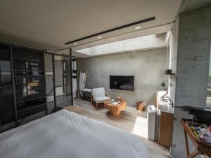 a bedroom with a bed and a living room with a fireplace at Deer Chaser Xitou in Lugu Lake