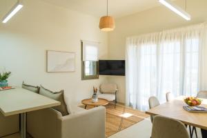 a living room with a table and a dining room at Villa Artemis 1 - Etheras Properties in Kythira