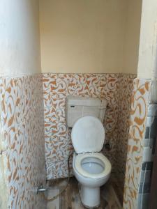 a bathroom with a toilet in a room at Vishawkarma Homestay in Gajraula
