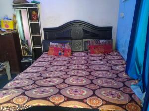 a bedroom with a bed with plates on it at Vishawkarma Homestay in Gajraula