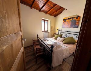 a bedroom with a large bed in a room at IL COLLE Holiday Home - FIUGGI - Charming independent home in the historic center, near the Thermal Baths & Wellness Retreats in Fiuggi