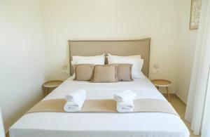 a bedroom with a bed with towels on it at Villa Artemis 1 - Etheras Properties in Kythira
