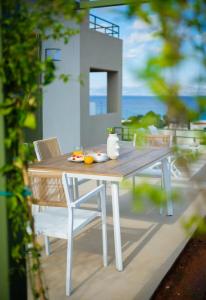 a wooden table and chairs on a patio at Villa Artemis 1 - Etheras Properties in Kythira
