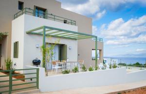 a white house with a view of the ocean at Villa Artemis 1 - Etheras Properties in Kythira