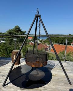 a metal swing on a patio with a view at GrebbestadFjorden glampingpoddar in Grebbestad +7 photos