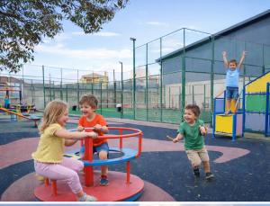 a group of children playing on a playground at casa rural El Burrillo in Cuenca