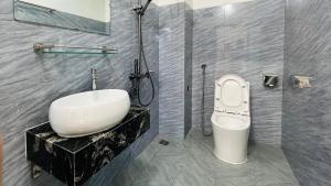 a bathroom with a sink and a toilet at Bao An Homestay Mai Chau in Mai Châu +49 photos