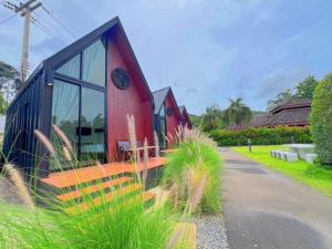 a red and blue building with a clock on it at Nordic SkyBird Hill Chill in Pak Chong