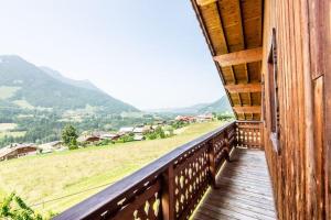 a balcony of a house with a view of a field at Ecrin des anges in Vacheresse +13 photos