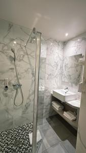 a bathroom with a shower and a sink at New Hôtel Gare Du Nord in Paris +79 photos