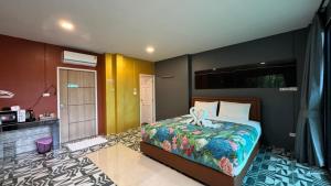 a bedroom with a bed with a ribbon on it at Khaolak Nature House in Khao Lak