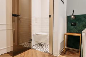 a bathroom with a toilet and a shower at Hotel Palais26 in Villach +36 photos