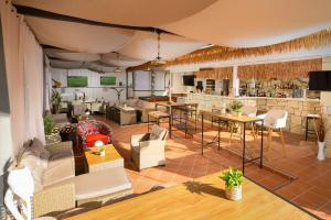 a large room with tables and chairs and a bar at Hersonissos Villas in Hersonissos