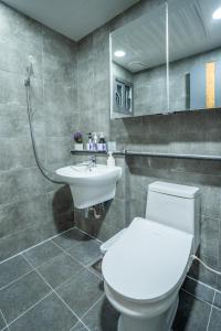 a bathroom with a toilet and a sink at Joohane Jejudo House in Jeju +69 photos