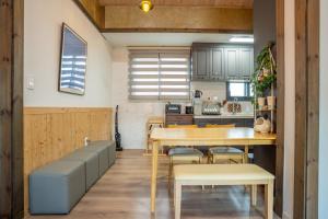 a kitchen and dining room with a table and chairs at Joohane Jejudo House in Jeju