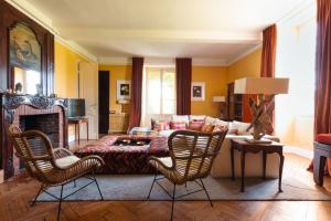 a living room with a couch and a table and chairs at Beaulieu Saint Come in Saint-Côme