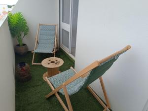 a balcony with a chair and a table at RIEZ Entre Mer et Dunes in Saint-Hilaire-de-Riez