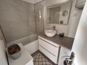 a small bathroom with a sink and a tub at RIEZ Entre Mer et Dunes in Saint-Hilaire-de-Riez +13 photos
