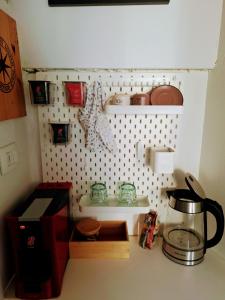 a kitchen counter with a sink and a coffee maker at Cozy City Centar Studio in Podgorica
