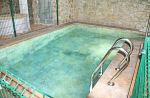 a large swimming pool with a metal staircase in it at Chalet El Palmar in El Palmar