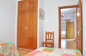 a bedroom with a bed and a closet and a chair at Chalet El Palmar in El Palmar +15 photos
