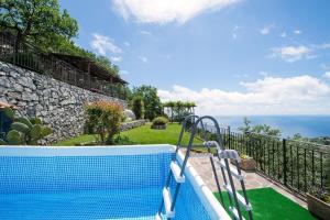 a swimming pool with a view of the ocean at Agriturismo Fattoria Terranova in SantʼAgata sui Due Golfi