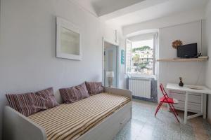 a living room with a couch and a red chair at Beautiful view apartment Riomaggiore, Cinque Terre in Riomaggiore