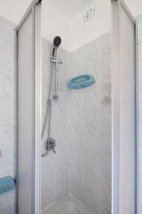 a shower with a glass door in a bathroom at Beautiful view apartment Riomaggiore, Cinque Terre in Riomaggiore +14 photos
