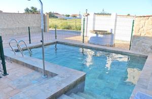 a swimming pool with a fence around it at Chalet El Palmar in El Palmar