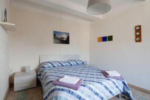 a bedroom with a bed with a blue and white comforter at Beautiful view apartment Riomaggiore, Cinque Terre in Riomaggiore
