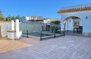 a patio with a fence in front of a house at Chalet El Palmar in El Palmar