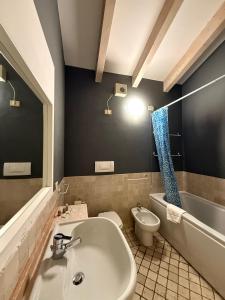 a bathroom with a white sink and a toilet at 1Dest - Queen of the Lake in Riva del Garda +65 photos