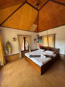 a bedroom with two beds in a large room at The Nest, Pai Love Resort in Thung Yao