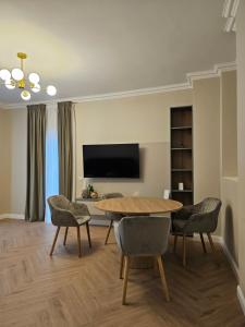 a living room with a table and chairs at ISHotel in Craiova