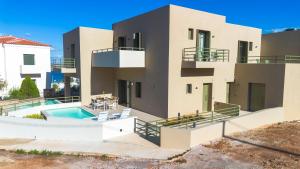 an exterior view of a house with a swimming pool at Villa Artemis 4 - Etheras Properties in Kythira