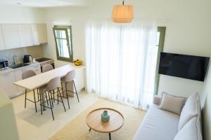 a living room with a couch and a table at Villa Artemis 4 - Etheras Properties in Kythira