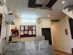 a room with a ceiling fan and a counter at Hotel Sudarshan in Haridwār