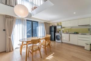 a kitchen and dining room with a table and chairs at Heaven Thonglor 36 - Villa in Bangkok