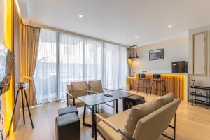 a living room with a couch and a table at Heaven Thonglor 36 - Villa in Bangkok