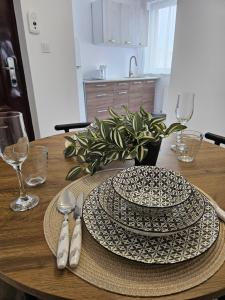 a wooden table with two plates and silverware on it at At Ladyluck in Suceava +5 photos