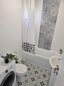 a bathroom with a toilet and a sink and a shower at At Ladyluck in Suceava