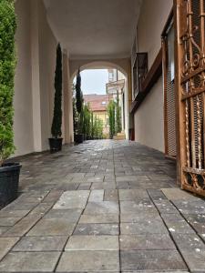 an empty courtyard with an archway in a building at ISHotel in Craiova