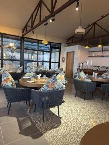 a restaurant with couches and tables in a room at Divine OAK Stay in Narendranagar