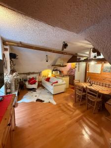 a living room with a couch and a table at Rifugio del vicolo in Lucoli Alto +31 photos