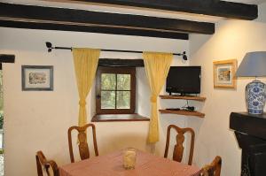 a dining room with a table and a window at Les Glycines Gîtes - Les Petites Pierres gîte - shared solar heated pool - garden spa - small dogs welcome in Vernoux-en-Gâtine
