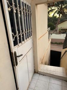 an open door with a view of a balcony at Room 01 in Serekunda +1 photo